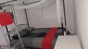 a bedroom with a bed with a canopy at Lisbon Hostel Terminal 3 in Lisbon