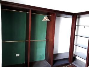 a green glass cabinet with a shoe hanging from it at La Chimenea Verde in Tacoronte