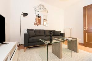 a living room with a couch and a glass table at Sonder Piazza San Pietro in Rome