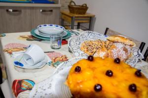 a table with a table cloth with food on it at Piana delle Galee in Scilla