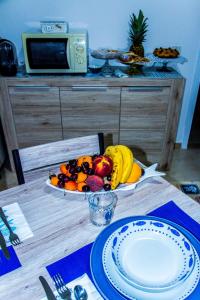 a table with a bowl of fruit on a plate at Piana delle Galee in Scilla