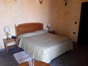 a bedroom with a bed and two tables with lamps at Palazzo Marzano in Briatico