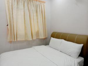 Taiping Cozy Homestay II房間的床