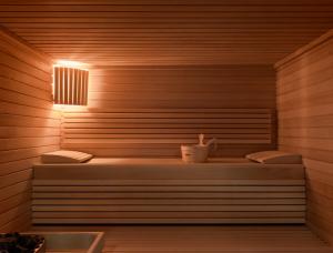 a sauna with two benches and a light on it at Okko Hotels Strasbourg Centre in Strasbourg