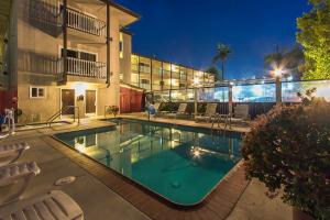 a swimming pool in front of a building at Avania Inn of Santa Barbara in Santa Barbara