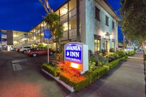 a sign in a parking lot in front of a building at Avania Inn of Santa Barbara in Santa Barbara