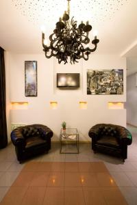 a room with two couches and a chandelier at Hotel Esplanade in Strasbourg