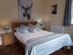 a bedroom with a bed with white sheets and pillows at The Stables - Deer Park Farm in Solihull