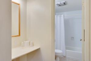 a white bathroom with a sink and a toilet at Zion Park Motel in Springdale