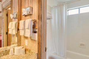 a bathroom with a shower and a sink and a mirror at Zion Park Motel in Springdale