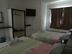 Una cama o camas en una habitación de Hotel Naj Kin