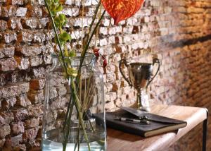 a vase with flowers in it sitting on a table at Villa360 in Amsterdam