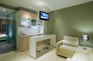 A kitchen or kitchenette at Ako Suites Hotel