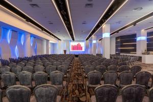 a conference room with chairs and a screen at U Magic Palace in Eilat