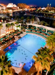 an overhead view of a large swimming pool at night at U Magic Palace in Eilat