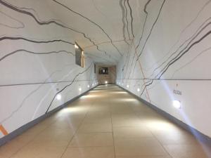 a long hallway with white marble walls and lights at Grand Hotel Lamezia in Lamezia Terme