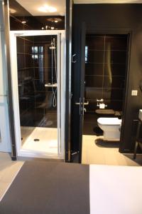 a bathroom with a toilet and a glass door at Arc de Triomphe Etoile in Paris