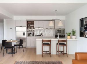 a kitchen with white cabinets and a table and chairs at ROOST East Market in Philadelphia