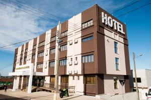 un edificio con una motocicleta estacionada frente a él en Laranjeiras Palace Hotel, en Laranjeiras do Sul