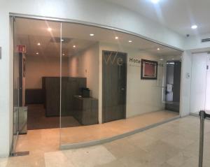 a lobby with a glass door in a building at We Hotel Aeropuerto in Mexico City