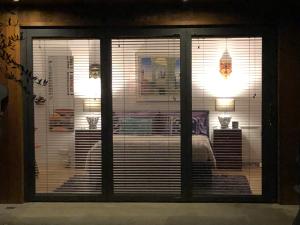 a sliding glass window with a view of a living room at Romantic Bungalow in Notting Hill in London