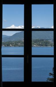 a view of the water from a window at Relais Casali della Cisterna in Belgirate