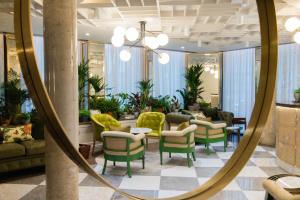 a mirror in a lobby with chairs and tables at Vintry & Mercer Hotel - Small Luxury Hotels of the World in London