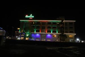 a building with lights on it at night at Sai Neem Tree Hotel in Shirdi