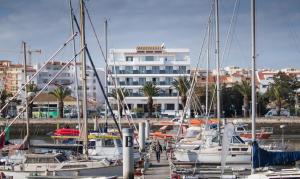 a group of boats docked in a marina with a building at Hotel Marina Rio in Lagos