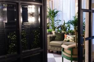 a living room with a couch and some plants at Vintry & Mercer Hotel - Small Luxury Hotels of the World in London