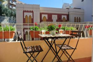 a table and two chairs on a balcony at B&B Pellicano Guest House in Reggio di Calabria