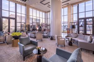 a lobby with couches and tables and windows at Braira Al Nakheel in Riyadh