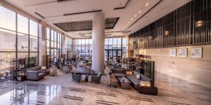 a lobby with chairs and tables in a building at Braira Al Nakheel in Riyadh