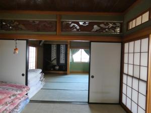 A bed or beds in a room at Minpaku Suzuki