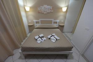 two towels on a bed in a room at Villa Saturno in Tropea