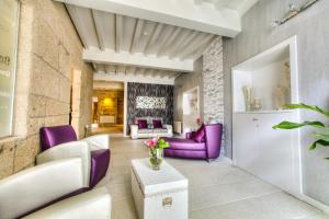 a living room with purple furniture and purple chairs at Hotel Montenegro Compostela in Santiago de Compostela