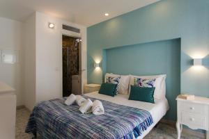 a bedroom with a large bed with a blue wall at Suites Amália Guesthouse near Rossio Square in Lisbon