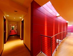 a hallway with red walls and a red wall at Luna Hotel Motel Lago Maggiore Arona in Oleggio Castello