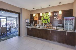 a restaurant with a counter with food on it at La Quinta by Wyndham Philadelphia Airport in Essington