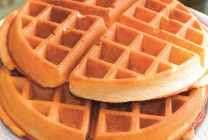 a stack of waffles on a white plate at La Quinta by Wyndham Philadelphia Airport in Essington