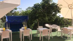 a group of tables and chairs under a blue tent at Villa Saturno in Tropea