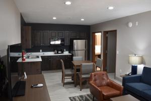 a kitchen and living room with a table and a blue couch at Zion Canyon Lodge in Springdale