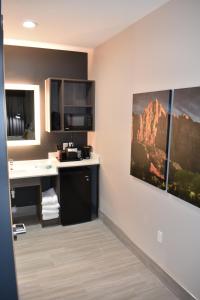 a hotel room with a kitchen with a painting on the wall at Zion Canyon Lodge in Springdale