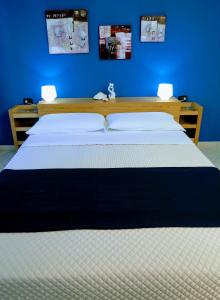 a bedroom with a large bed with a blue wall at Zama Bed&Breakfast in Scalea