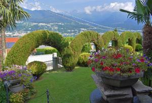 a garden with flowers in the shape of the word garden at Albergo Ristorante Conca Azzurra in Colico