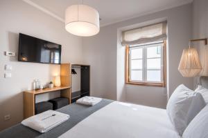 Una cama o camas en una habitación de Urbano FLH Hotels Lisboa