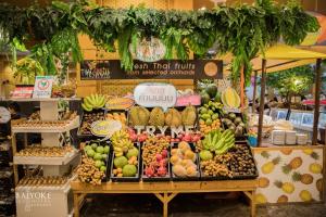 a fruit stand with a variety of fruits and vegetables at Baiyoke Sky Hotel in Bangkok