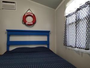 a bedroom with a bed with a red ring on the wall at Tiny House Siesta in Sarasota