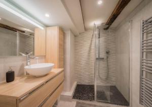 a bathroom with a sink and a shower at Le Carré d'or - Appartement avec vue Cathédrale in Strasbourg