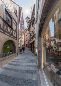 an alley in an old town with a cathedral at Le Carré d'or - Appartement avec vue Cathédrale in Strasbourg